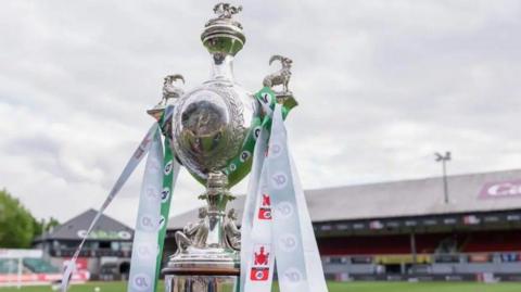 The Welsh Cup trophy on a plinth inside a ground