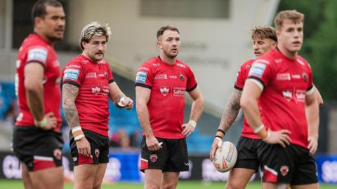 Salford Red Devils stand dejected against Hull FC earlier this season
