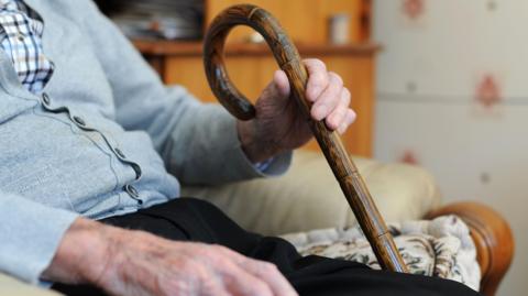 Man holding walking stick