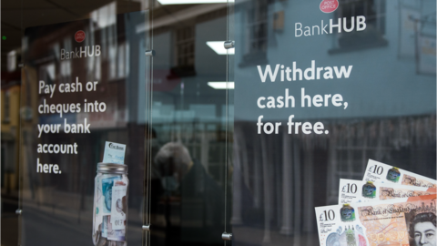 the glass doors to the entrance of a bank hub