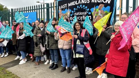 Sir Francis Hill Community Primary School staff on a picket line holding placards