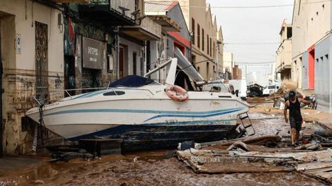 Street with boat in it following floods in the province of Valencia, eastern Spain in October 2024