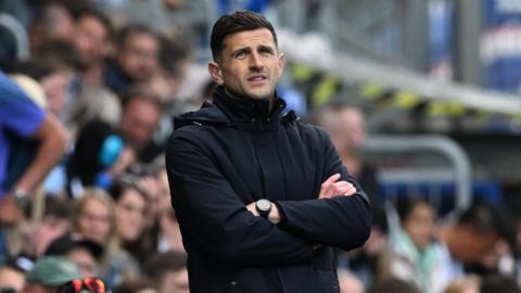 Portsmouth boss John Mousinho looks on from the sidelines