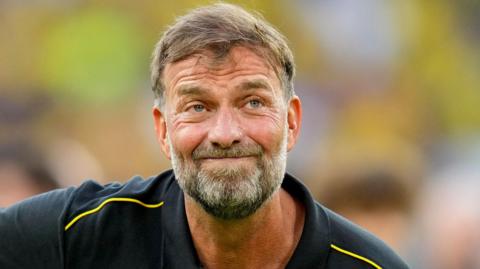 Jurgen Klopp stifles a smile during a Borussia Dortmund farewell match for Lukasz Piszczek and Jakub Blaszczykowski