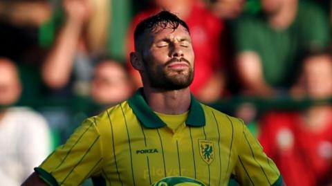 Ben Nash of Caernarfon Town is disappointed after being sent off