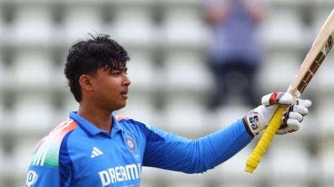 Vaibhav Suryavanshi raises his bat in recognition of his century