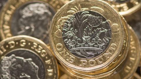 A pile of £1 coins.