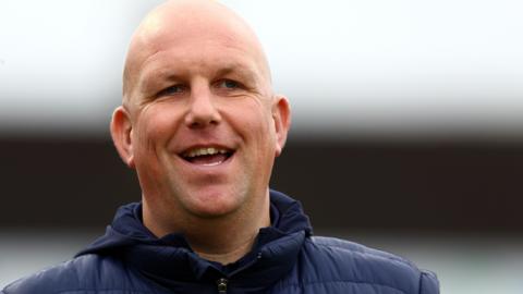 Matt Gray smiles during his time in charge of Sutton United