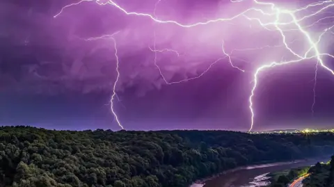 Lightning strikes during thunderstorm seen from over the Portway in Bristol