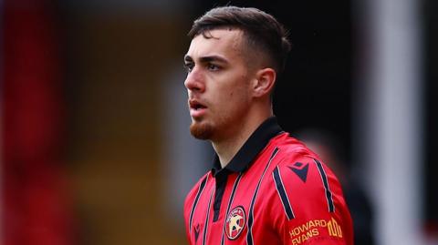Taylor Allen prepares to take a throw in for Walsall