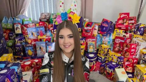 Girl surrounded by Easter eggs