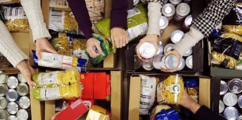 Hands preparing a foodbank parcel