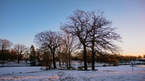 Snow covers the ground at a park in Colchester.