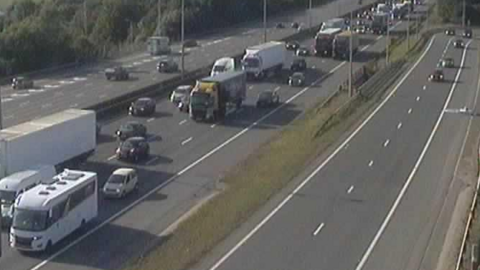 Traffic approaching junction nine on the M1 in Hertfordshire. The cars, lorries and vans are backed up. 
