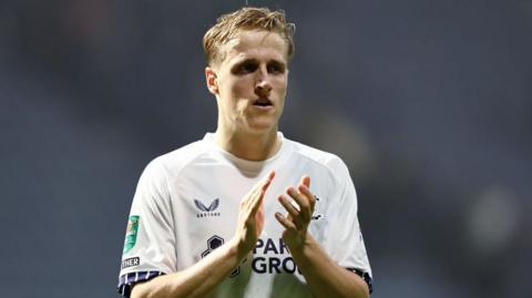 Jeppe Okkels applauds Preston supporters.