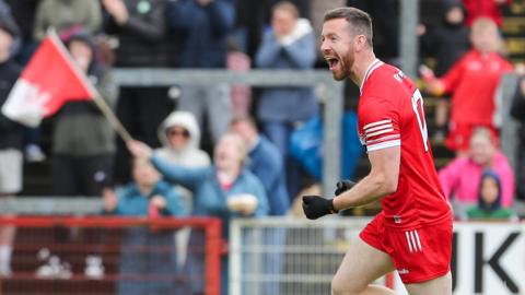 Niall Loughlin celebrates scoring a goal for Derry in a game at Celtic Park