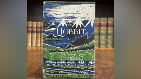 Copy of 'The Hobbit' by J. R. R. Tolkien sitting on a wooden surface