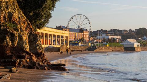 Barry Island seen from the beach with ferris wheel in the background