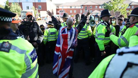 Anti-immigration protester surrounded by police at Crawley