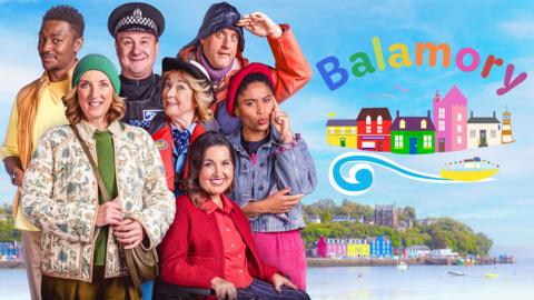 The colourful cast of Balamory in front of their town.
