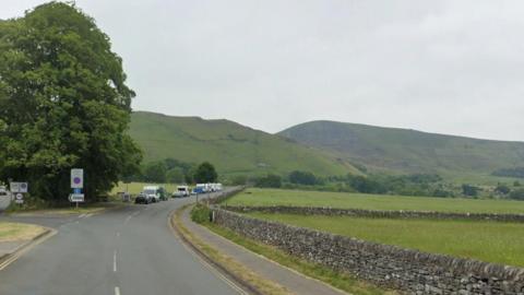 A street view of hills surrounding Old Mam Tor Road,