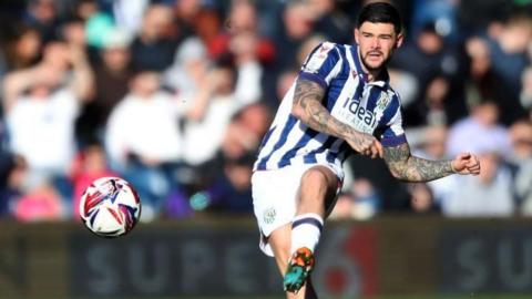 Alex Mowatt strokes the ball forward left footed during a match for West Bromwich Albion