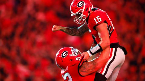 Carson Beck and Dylan Fairchild of the Georgia Bulldogs celebrate after a touchdown during the second quarter against the Tennessee Volunteers at Sanford Stadium on November 16, 2024 in Athens, Georgia.