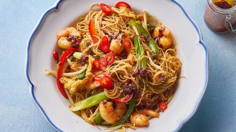 Singapore vermicelli in a white dish with a light blue background