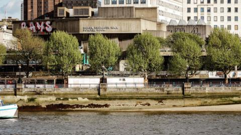 A view of the National Theatre - a brutalist building - from the other side of the Thames