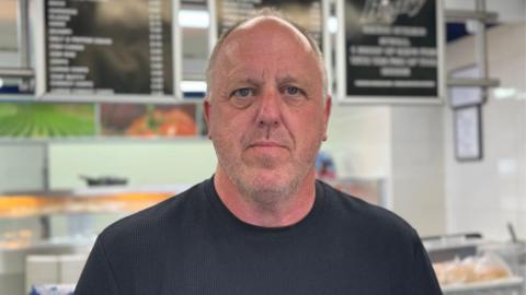 A man in a black t-shirt. 