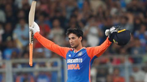 Abhishek Sharma celebrates his hundred against India by raising his bat and helmet