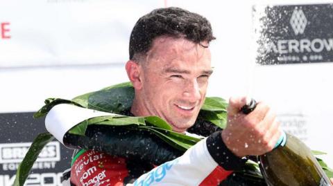 Glenn Irwin celebrates one of his 11 consecutive Superbike race wins at the North West 200