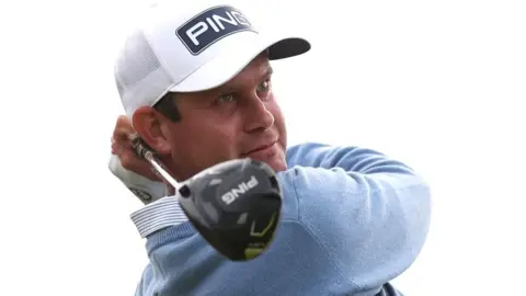 Lee Westwood hits a tee shot on the seventh hole