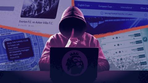 Hooded figure by a laptop
