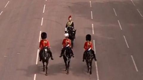 Three solders on horseback take part in the VE Day military parade