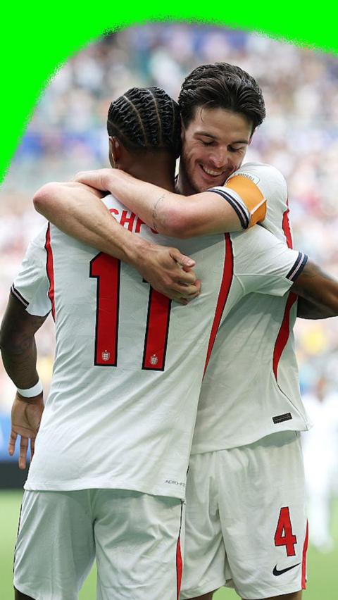 Declan Rice and Marcus Rashford hug to celebrate Rice's opening goal for England against France in the 2026 World Cup.