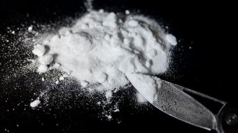 Generic image of a small pile of a white powdered drug on a black background