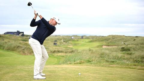 Lee Westwood hits a tee shot on the seventh hole