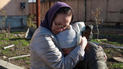 Two female residents in Odesa comfort each other after a Russian missile strike on November 17, 2024