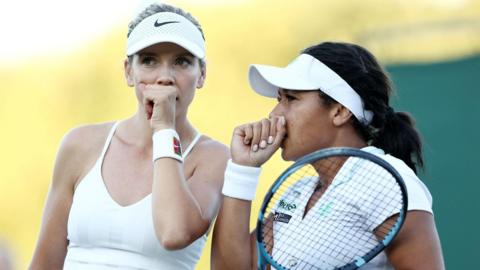 Katie Boulter and Heather Watson discuss tactics during their doubles match at Wimbledon 