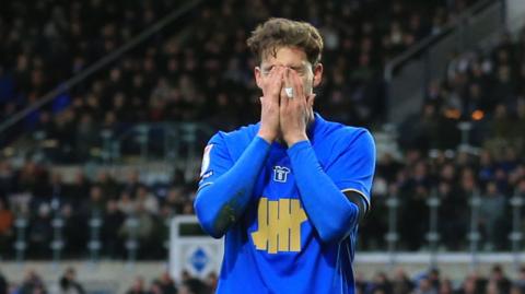 Birmingham City's Phil Neumann puts his hands over his face after scoring an own goal against Stoke City