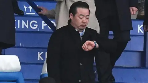 Leicester City CEO Aiyawatt Srivaddhanaprabha looks at his watch