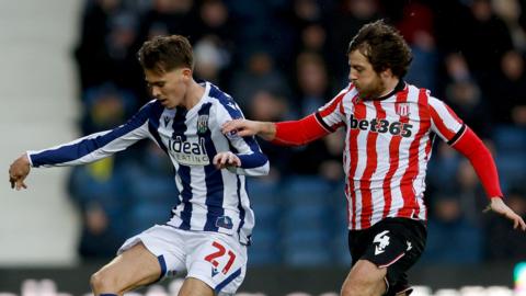 West Brom midfielder Isaac Price and Stoke City midfielder Ben Pearson battle for the ball