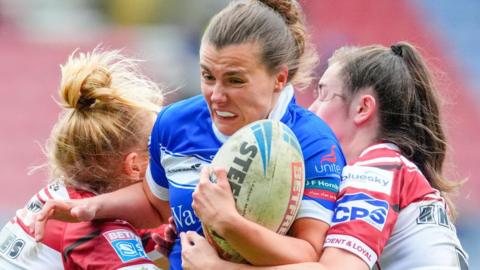 Emma Hutchinson carries the ball into contact for Barrow Raiders against Wigan Warriors