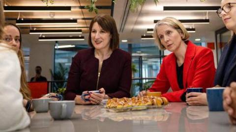 Emma Reynolds (R), with Chancellor Rachel Reeves (L), meeting employees during a visit to a biotech firm in London in November 