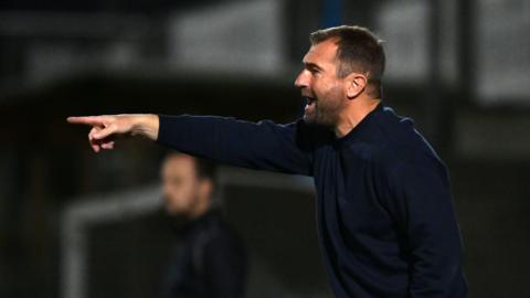 Torquay United manager Paul Wotton points and shouts orders