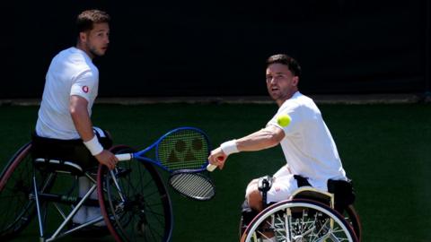 Gordon Reid and Alfie Hewett mid-rally in their Wimbledon final