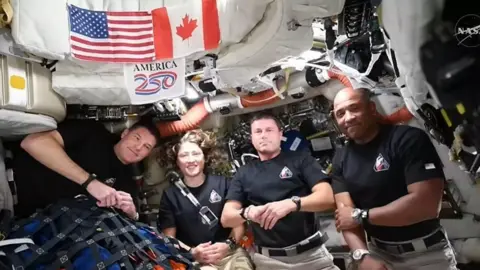 Artemis II astronauts doing presser from Orion spacecraft.