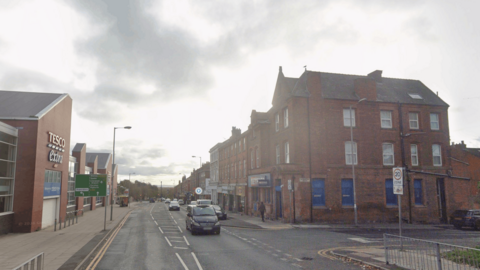 A Google Maps Street View screen grab of Park Road. A Tesco Extra is visable on the left-hand side. 