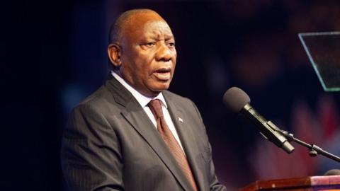 South African President Cyril Ramaphosa, in a suit, speaks during the G20 foreign ministers meeting in Johannesburg on 20 February 2025